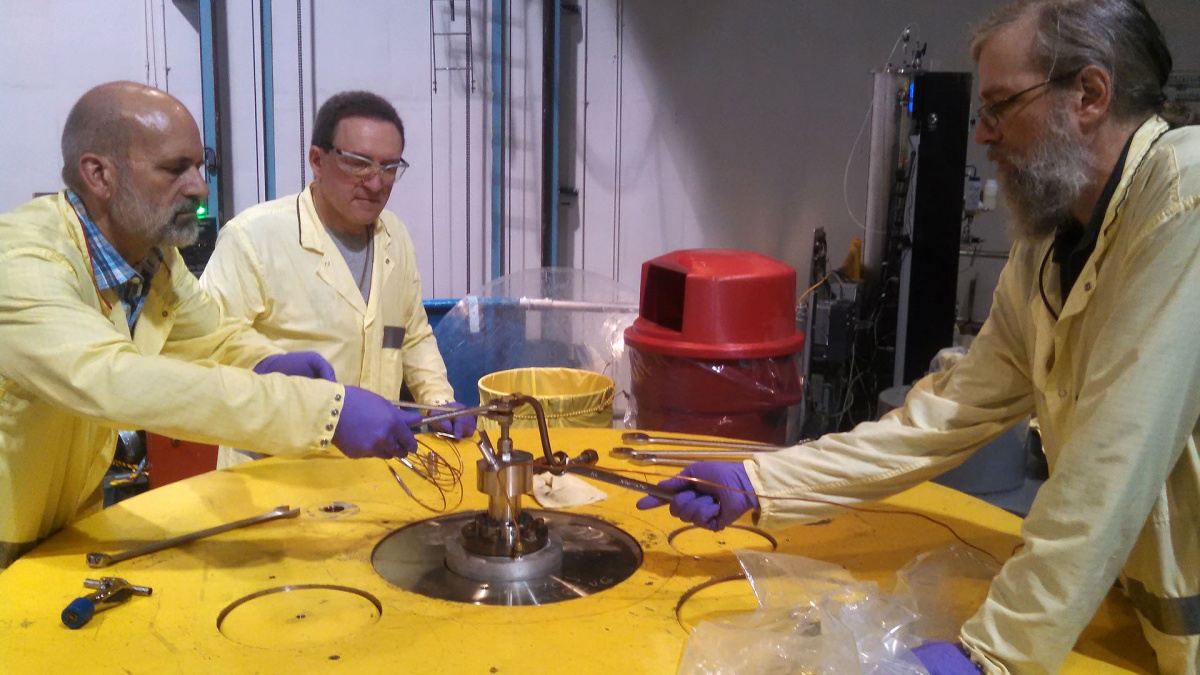 Gordon Kohse, Yakov Ostrovsky, and Michael Ames at the reactor top making adjustments to an in-core experiment